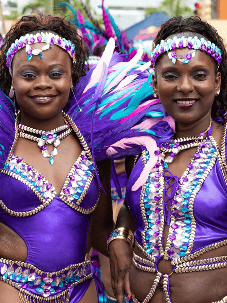 Vibrant Carnival costumes with feathers, beads, and jewels in purple color, showcasing cultural celebration and traditional attire.