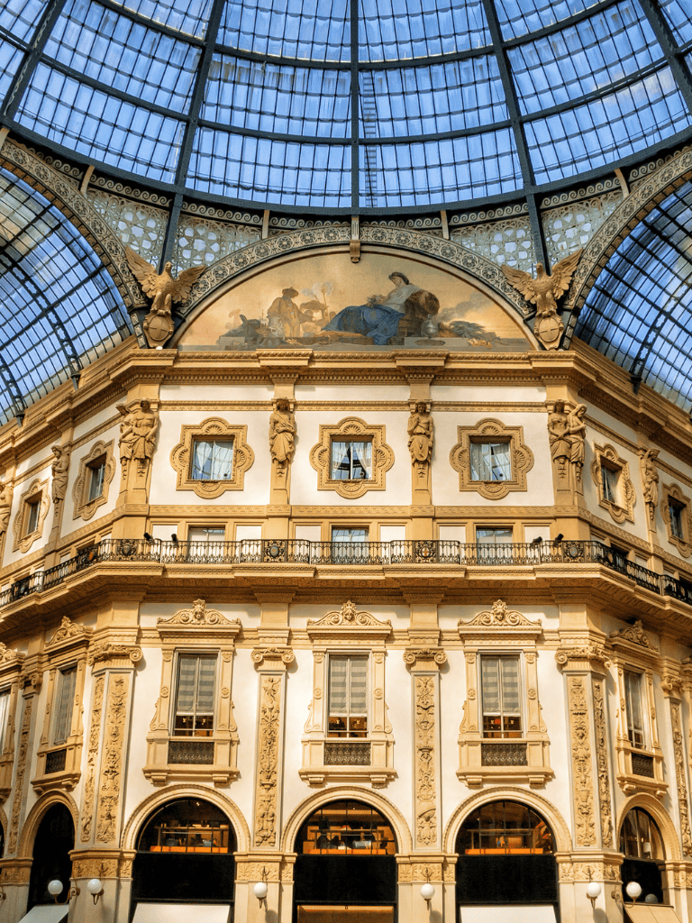 Opulent historic building with ornate architecture and glass-domed ceiling.