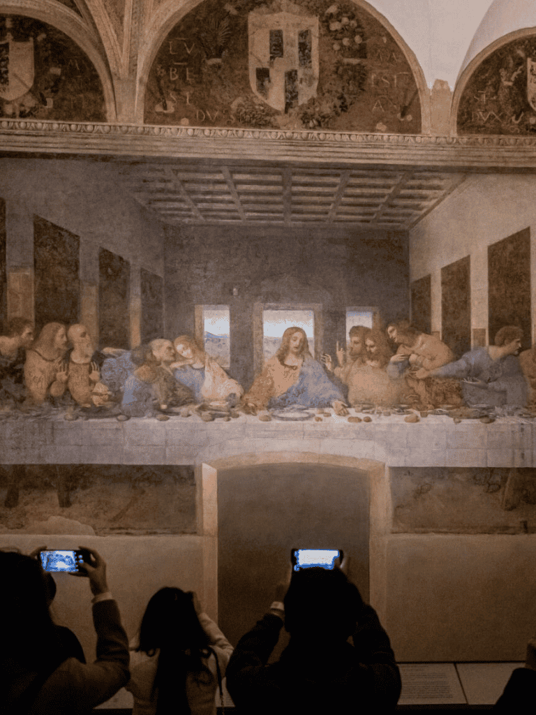 A large reproduction of Leonardo da Vinci's The Last Supper displayed in a museum setting.