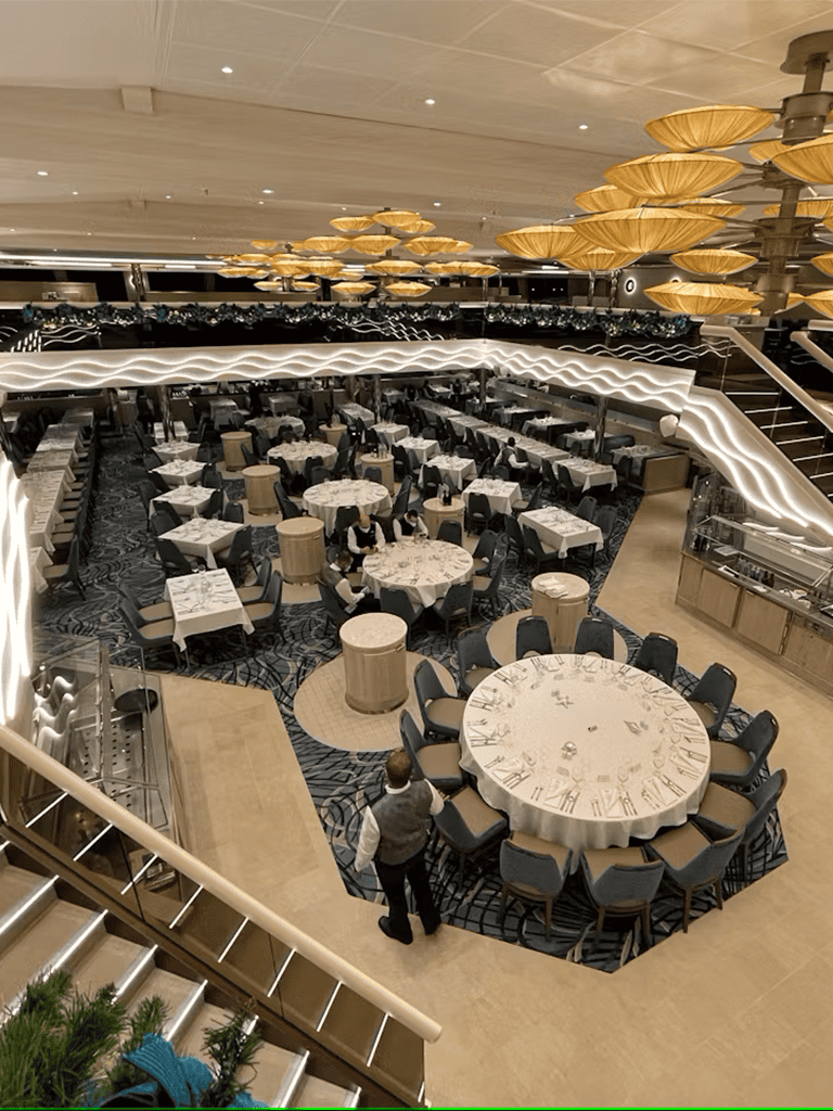 Elegant restaurant interior with round tables, modern lighting, and a spacious dining area for events and gatherings.
