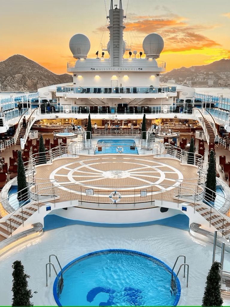 Luxury cruise ship deck at sunset with multiple pools and panoramic views, QuestForDirections cruise vacation SEO.