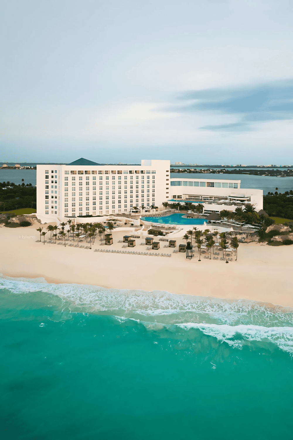 Modern beachfront hotel with ocean view, swimming pool, and resort amenities.