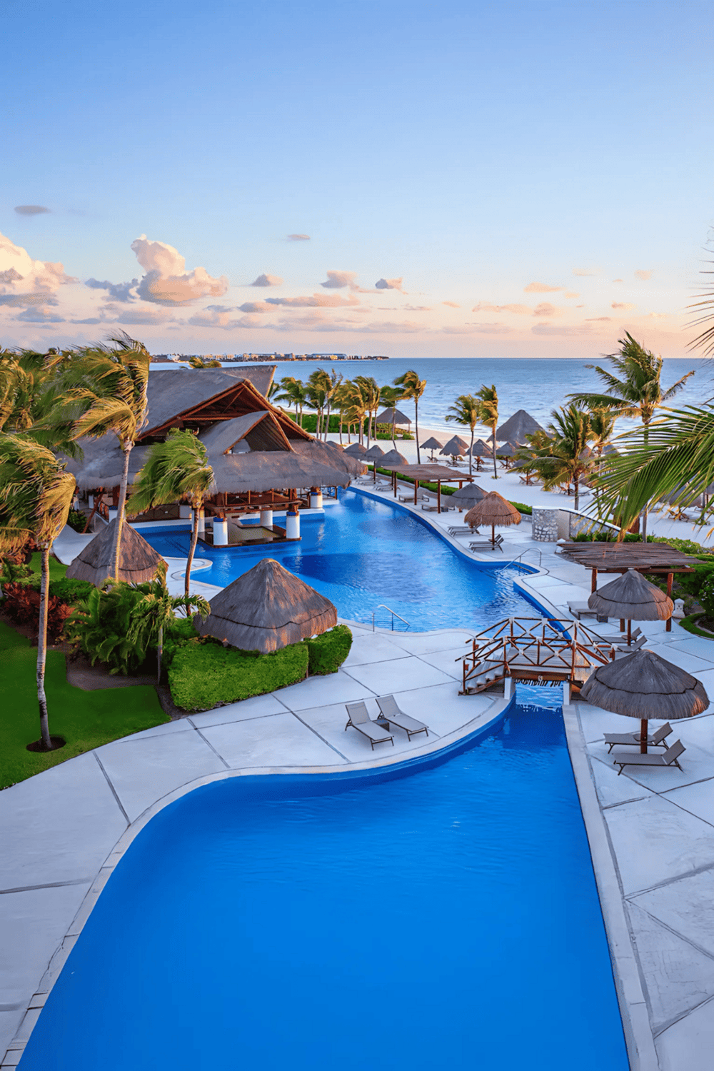 Luxurious beach resort with infinity pools, tropical palm trees, and ocean views, perfect for a relaxing vacation.