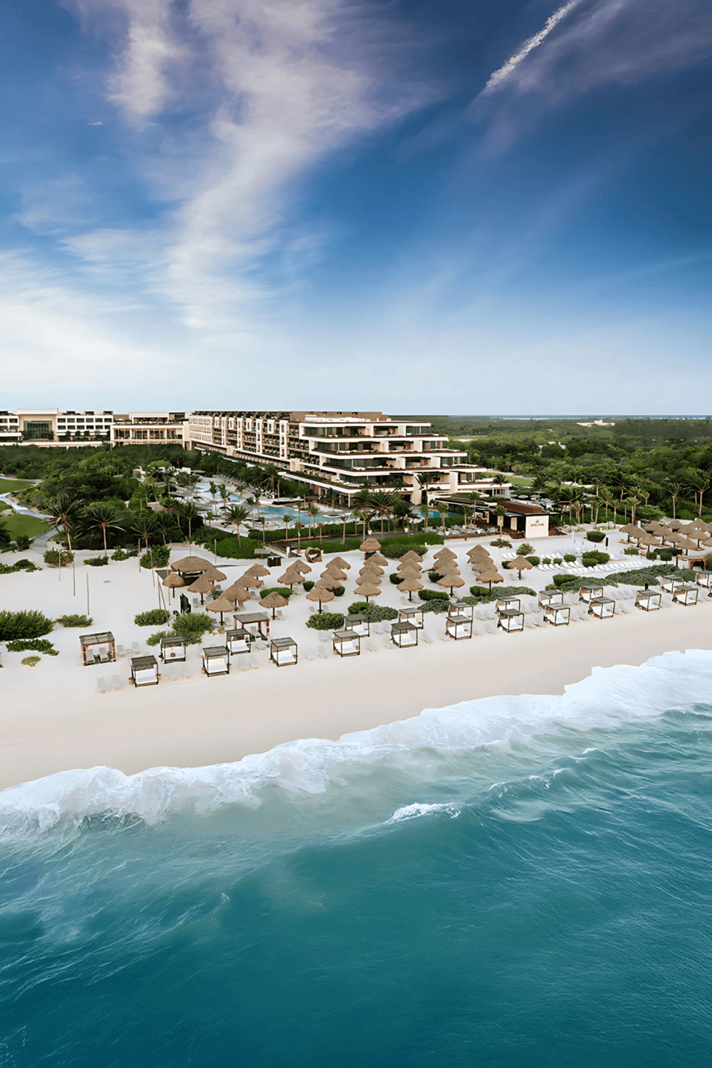 Elegant beachfront resort with ocean views, lush greenery, and luxurious accommodations.