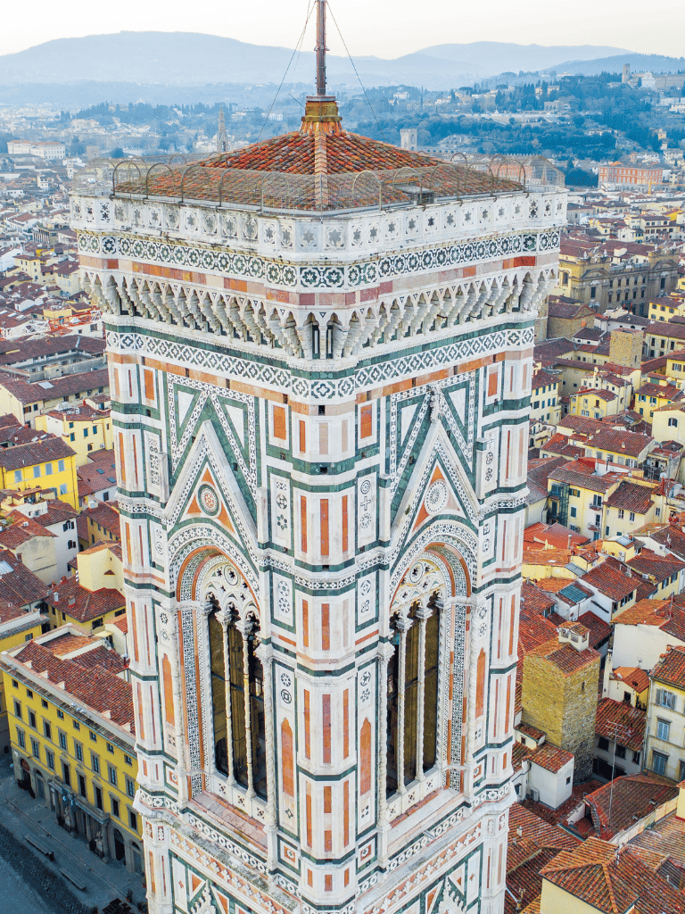 Colorful Florence Cathedral Tower, Italy, with skyline and historic cityscape in background.