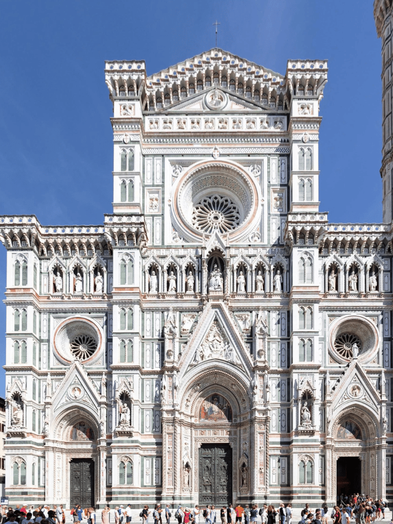 Intricate Florence Cathedral facade with detailed marble work and sculptures, a landmark for travelers exploring Italy.