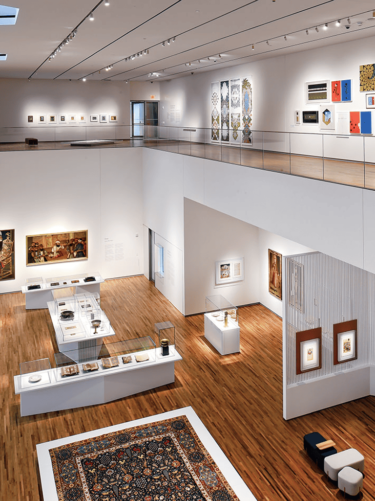 Intricate contemporary art and textiles displayed in a modern museum gallery.