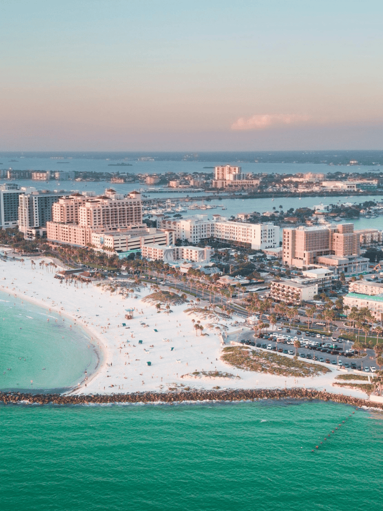 Vibrant coastal cityscape with beaches, modern buildings, and water views, perfect for travel and tourism.