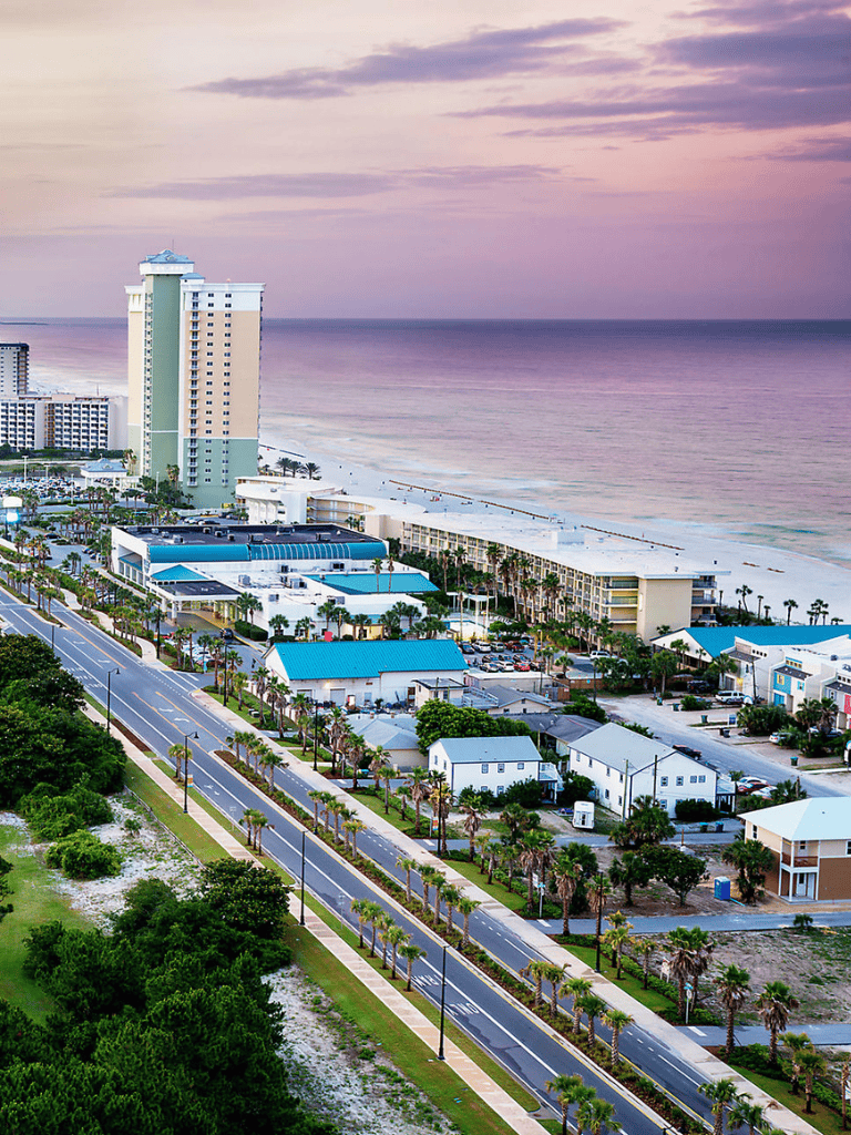 Breathtaking beachside view of high-rise hotels and ocean sunset in Panama City Beach, Florida.