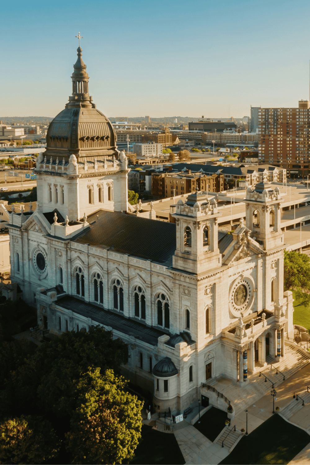 Ornate courthouse with clock tower in city skyline, daytime cityscape with historic architecture, urban downtown with high-rise buildings.