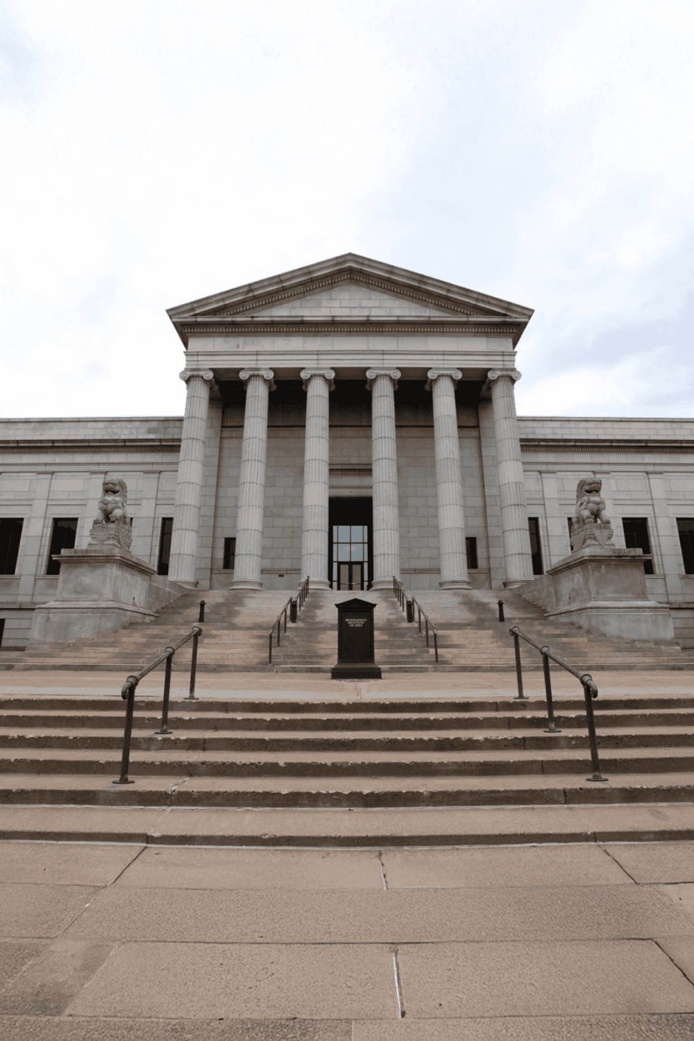 Classic government building with grand columns and stone statues, symbolizing navigation and direction services.