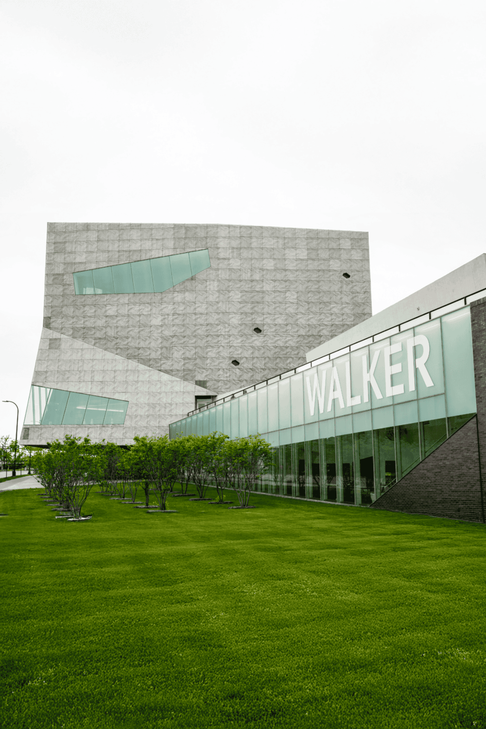 Modern architectural museum building with Walker signage and landscaped greenery, innovative cultural space.