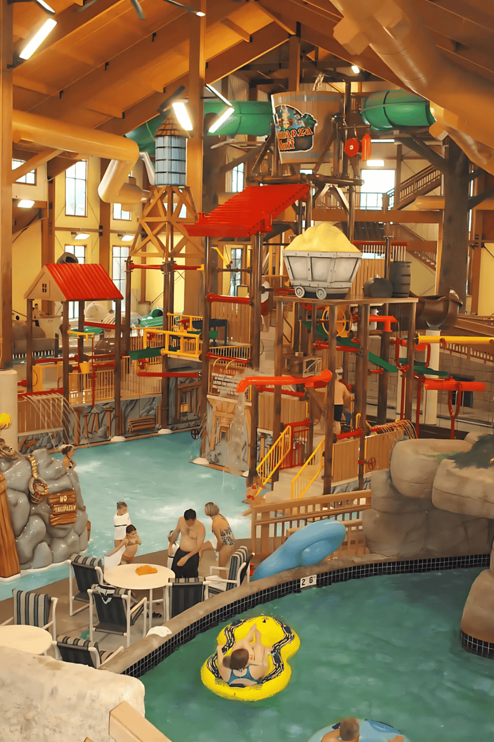 Indoor water park with slides and swimming pools for family fun and entertainment.