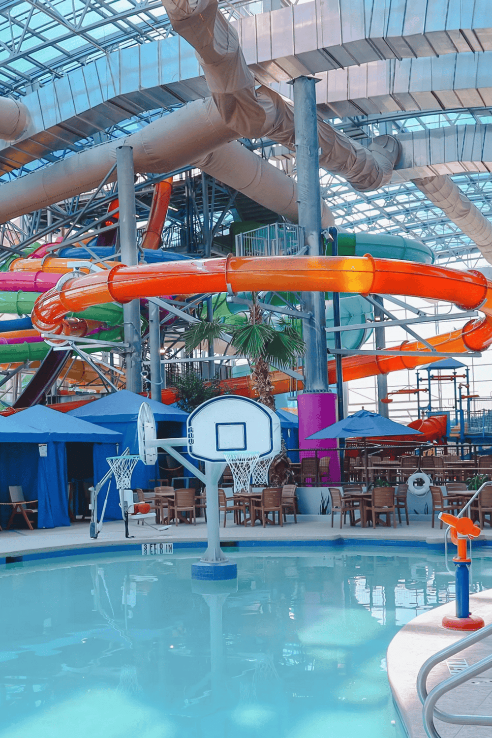 Bright indoor water park with colorful waterslides and pool at Quest for Directions, ideal for family fun and adventure.