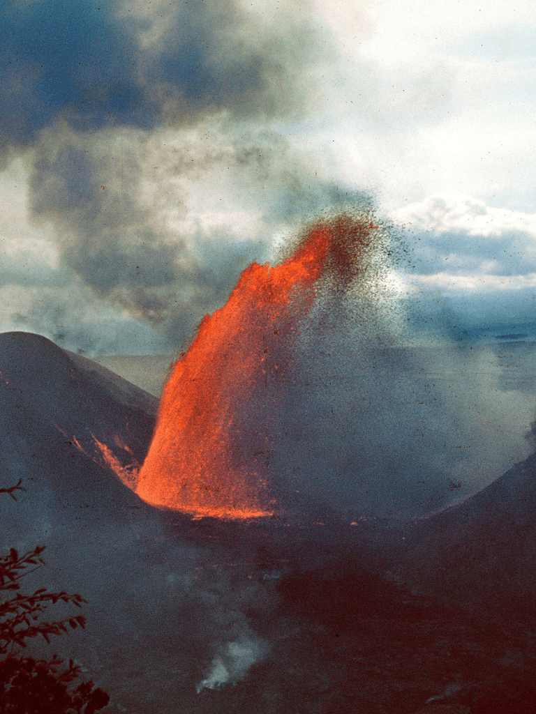 Lava eruption from volcano with dark smoke and ash in sky, volcanic activity, natural disaster scene.