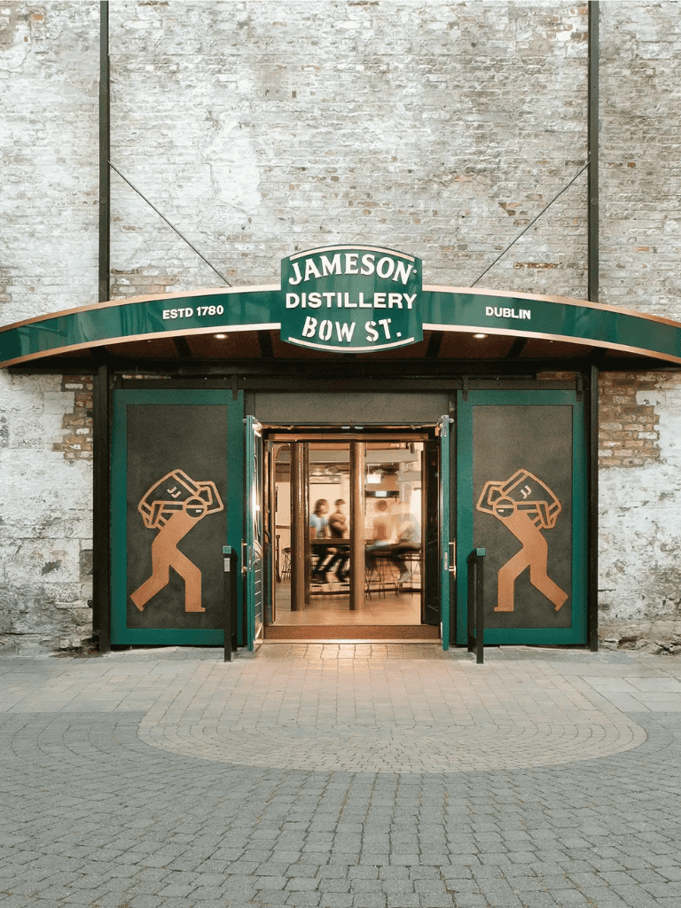 Party bar entrance with Irish whiskey branding, illuminated signage, and artistic door decals.