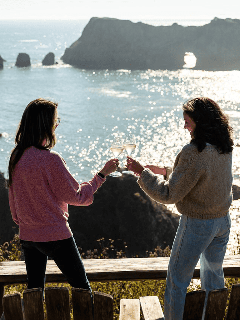 Enjoying wine together overlooking scenic cliffs and ocean at QuestForDirections.