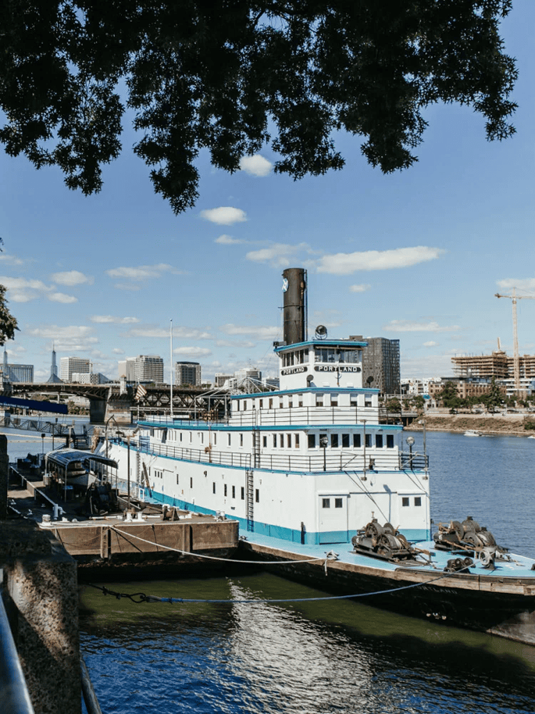 1. historic river steamboat docked in Portland with city skyline in background.