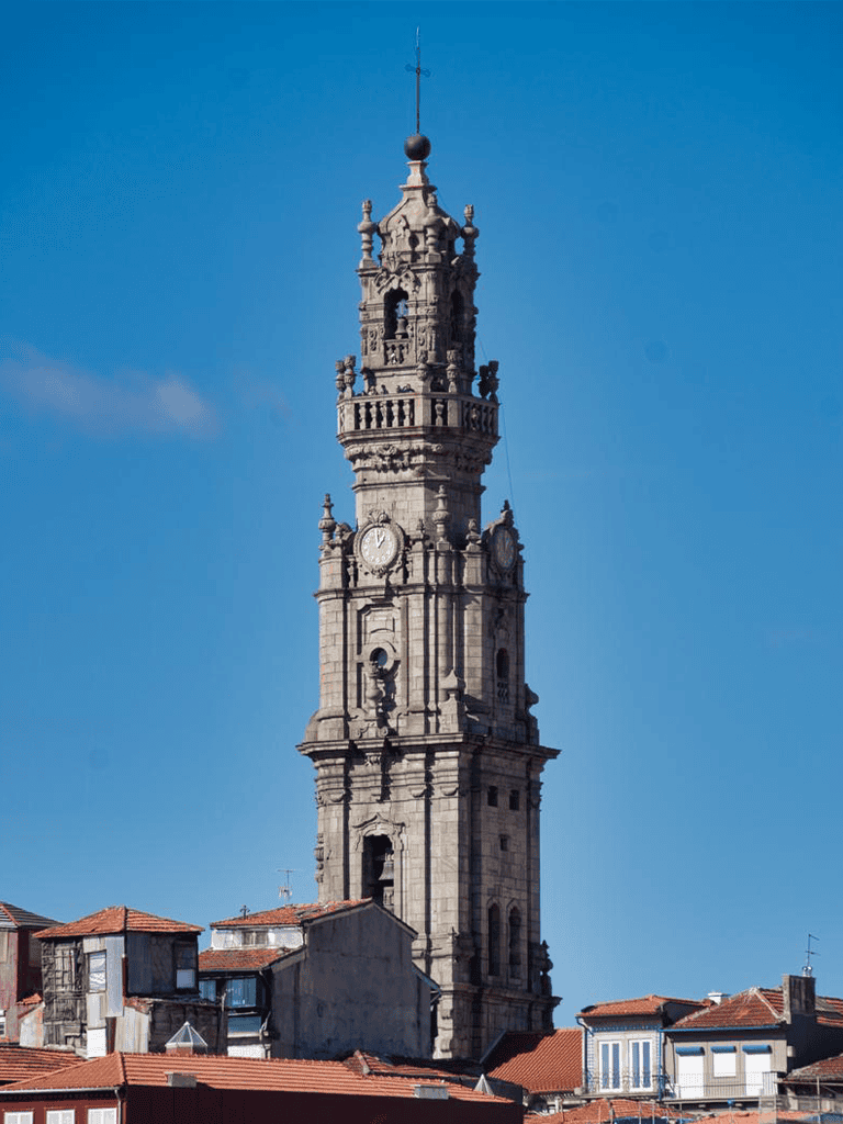 Historic clock tower in downtown Porto, Portugal, showcasing architectural beauty and city landmarks.
