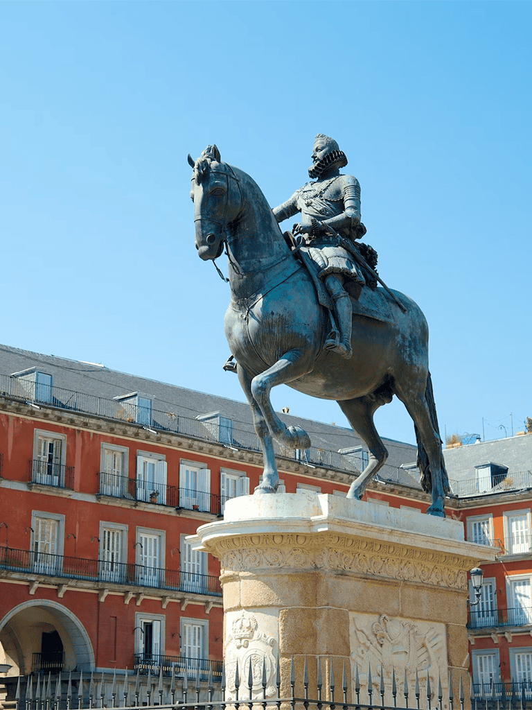Statue of Don Pedro, Madrid, Spain, on an ornate pedestal, historic European city background, popular tourist landmark.
