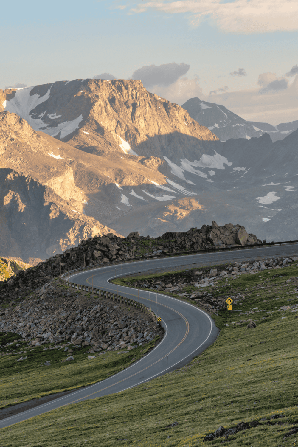 Scenic mountain road in Idaho with rugged peaks and winding pavement, perfect for outdoor adventures and travel planning.
