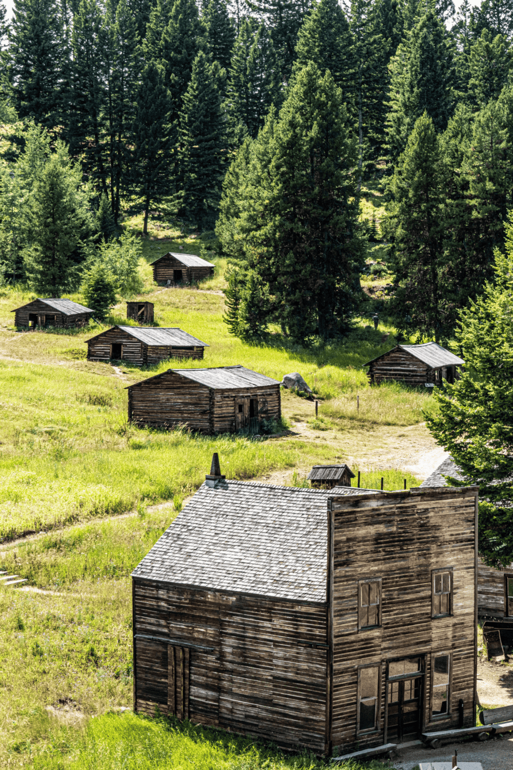Old rustic cabins in a scenic forested mountain setting, perfect for outdoor adventure and nature exploration.