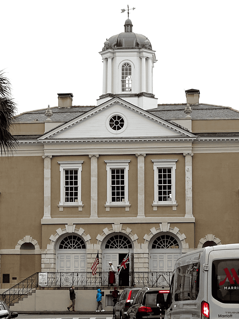 Elegant historic church with classical architecture and flags outside, located in downtown.