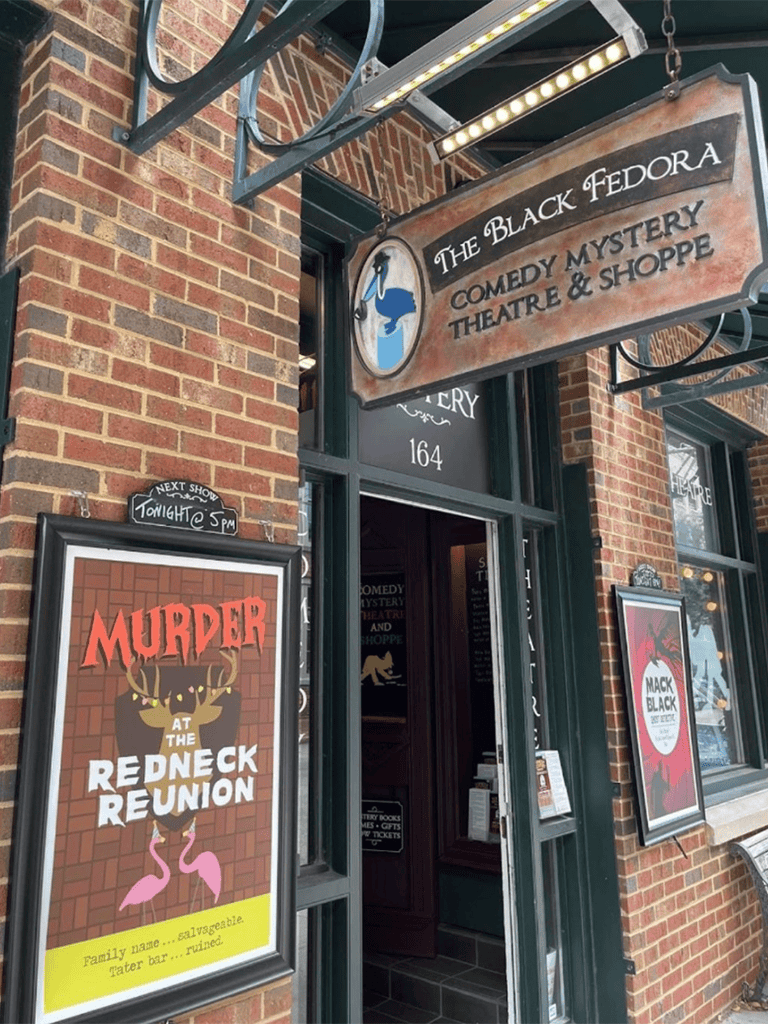 Charming comedy mystery theatre and shop in brick building, offering entertaining performances and unique gifts.