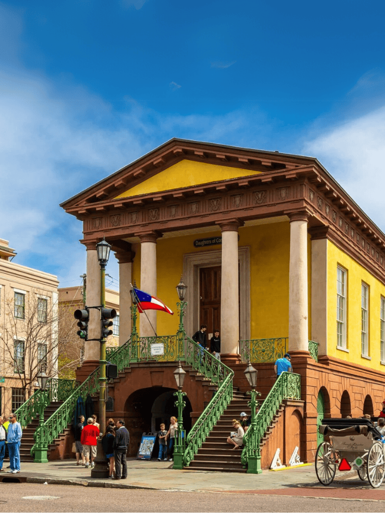 Daughters of Confederacy historic building with bright yellow facade and green staircase.