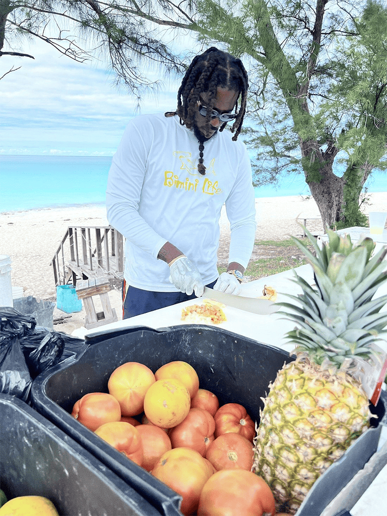 Fresh tropical fruits, pineapple, and tomatoes at QuestForDirections beachside market, perfect for summer recipes and healthy snacking.