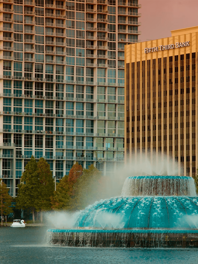 Downtown skyline with water fountain and high-rise buildings in a modern cityscape.