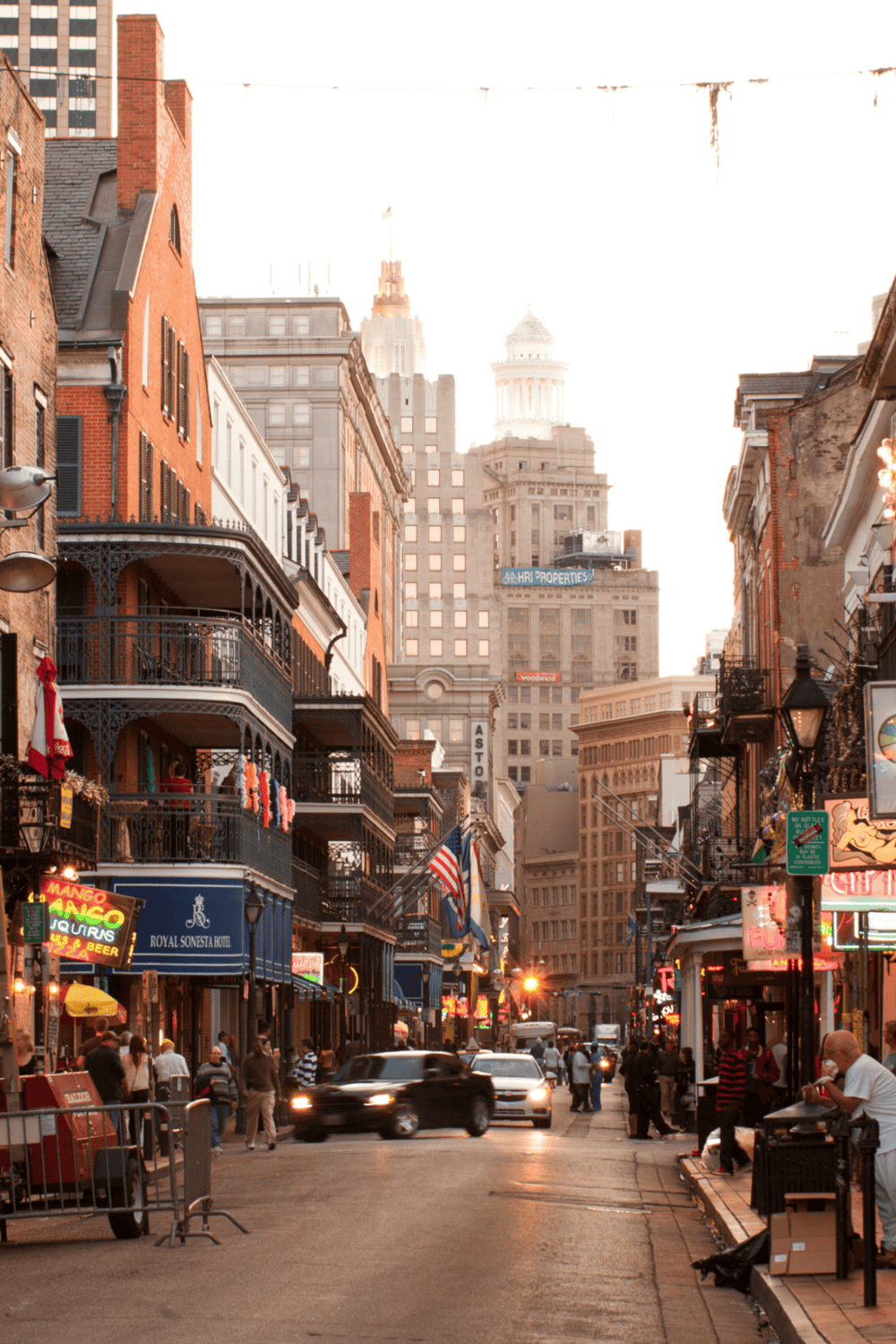 Bustling city street in downtown with vibrant nightlife, diverse crowd, and iconic architecture, perfect for urban exploration.