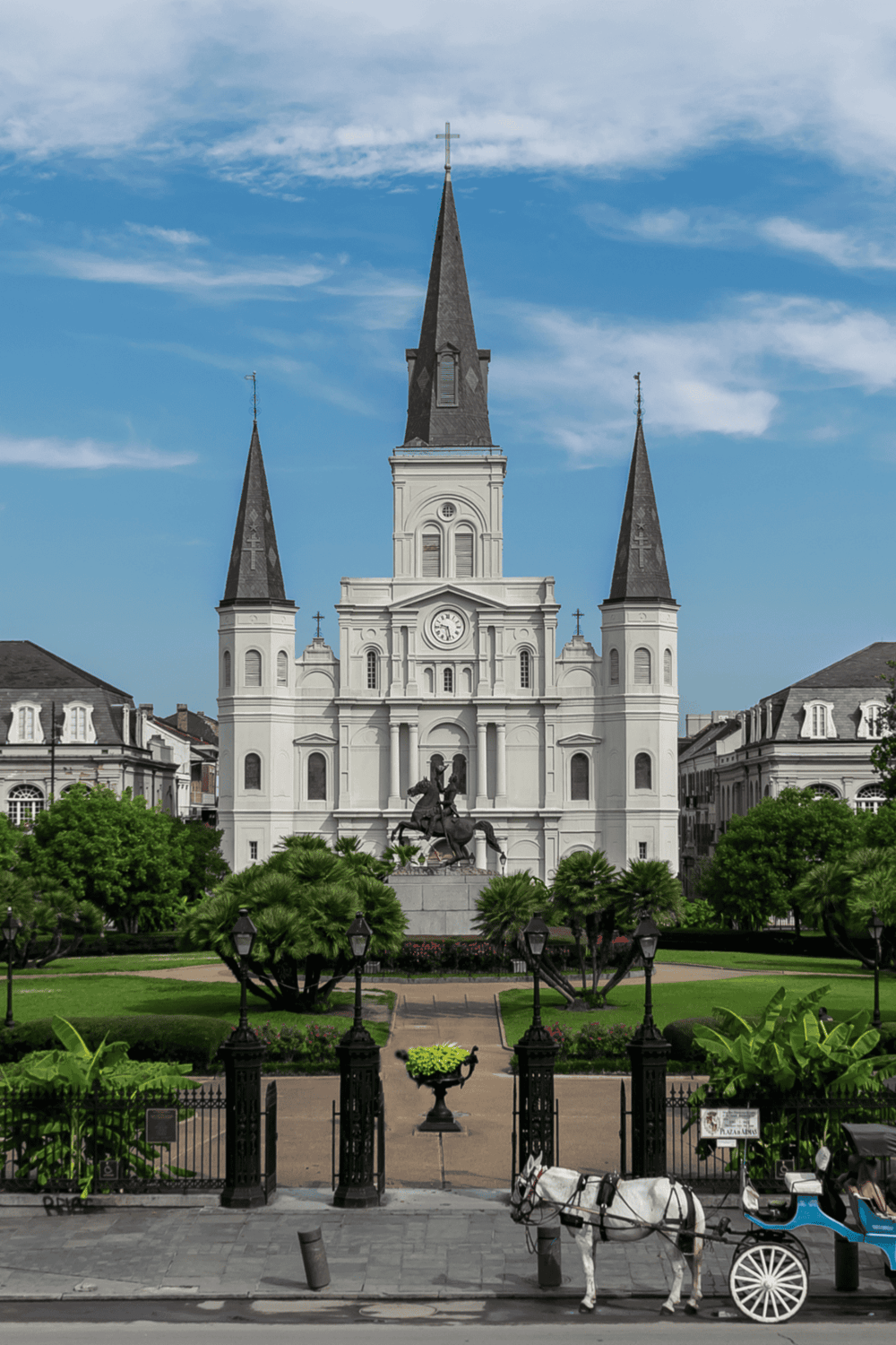 Orleans Cathedral, historic church with tall steeples in a city square, Louisiana, USA.