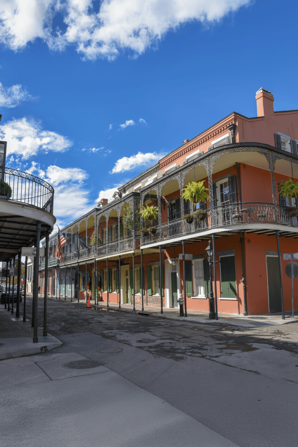 Charming historic buildings with colorful facades and cast-iron balconies in a vibrant city street.