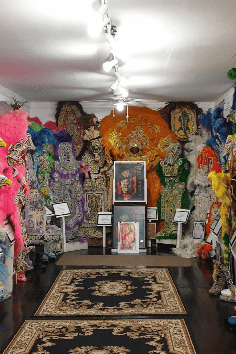Colorful traditional African masks and costumes display with intricate beadwork and feathers at QuestForDirections.
