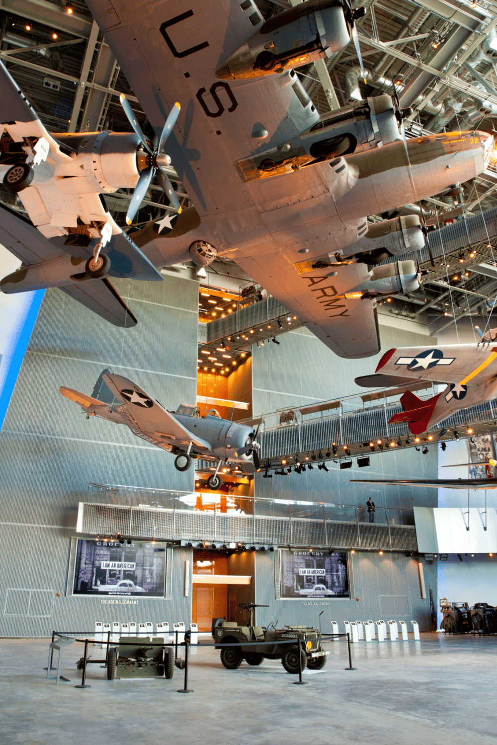 Vintage military aircraft and helicopters on display at a museum exhibit.