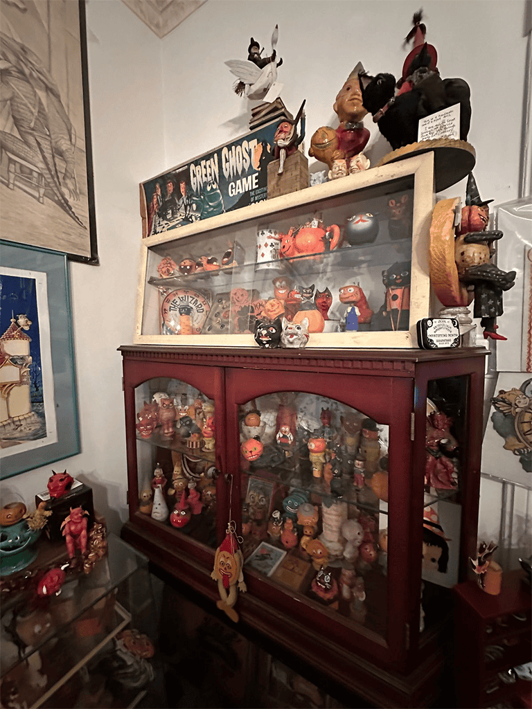 Vintage ceramic toy collection display cabinet showcasing unique handmade figurines.