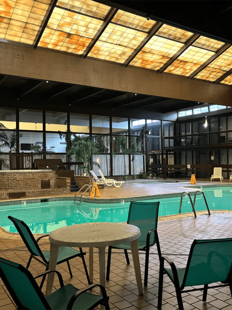 Indoor swimming pool with lounge chairs and tropical plants, perfect for relaxation at QuestForDirections.