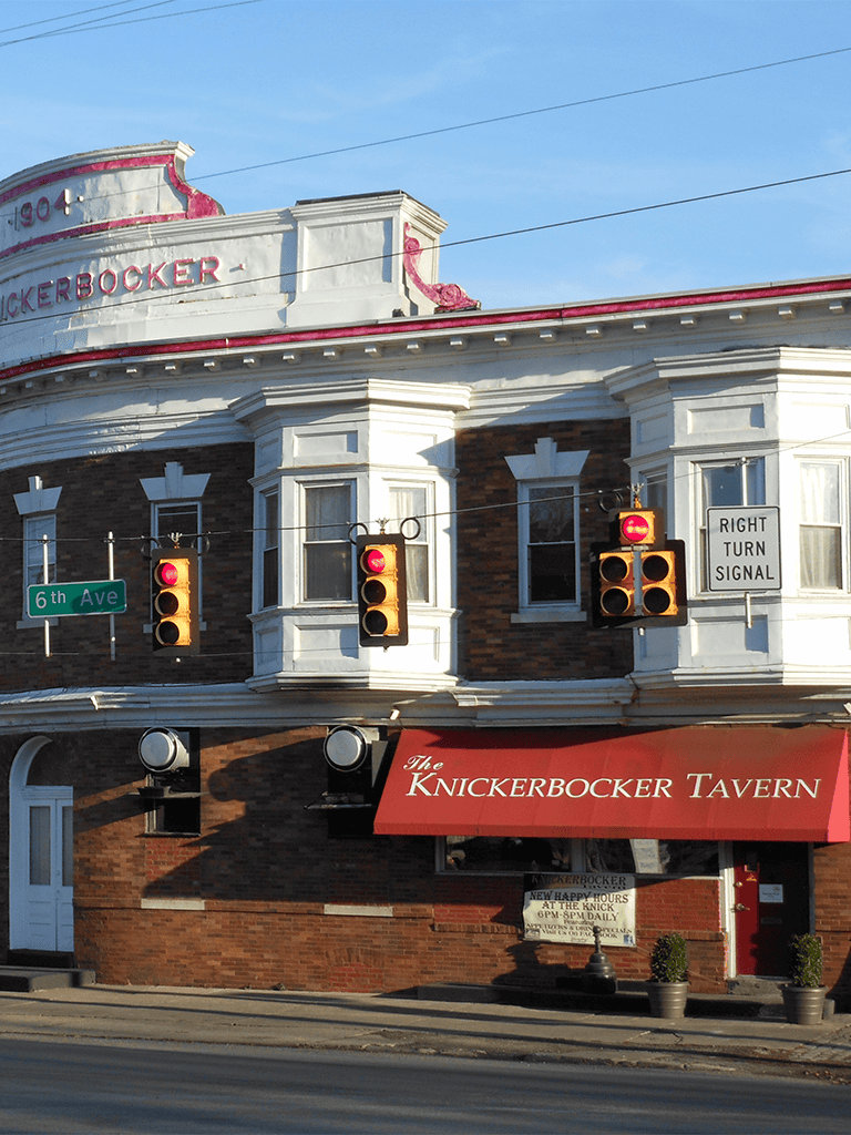 1. Historic Knickerbocker Tavern with traffic lights and street signs in downtown.