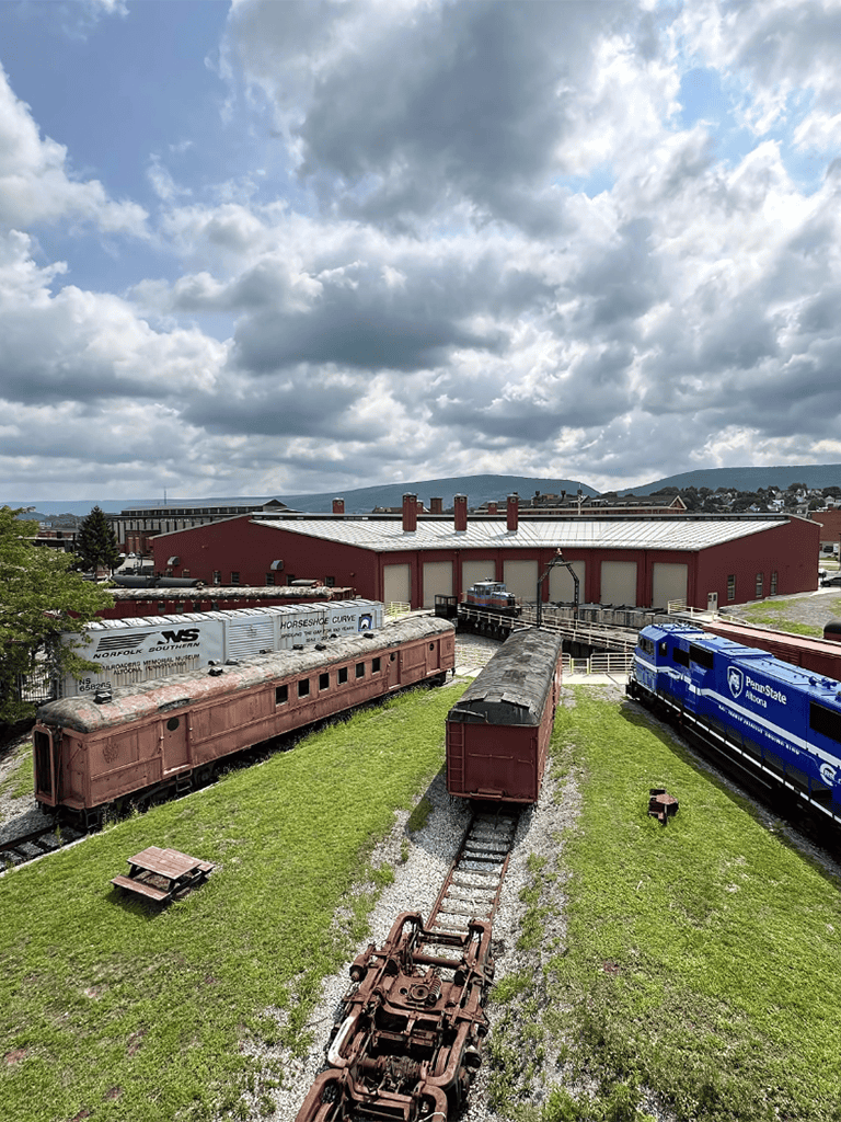Vintage train cars on historic railway tracks at QuestForDirections museum.