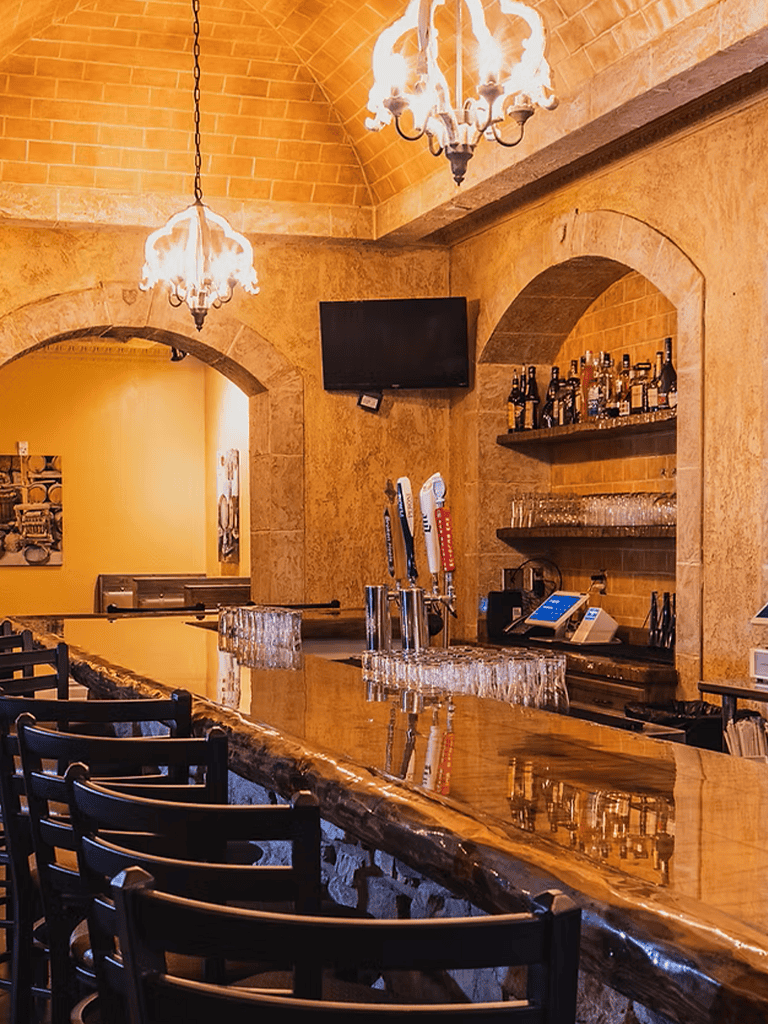 Cozy bar with exposed brick walls, warm lighting, and a polished wooden counter at QuestForDirections.