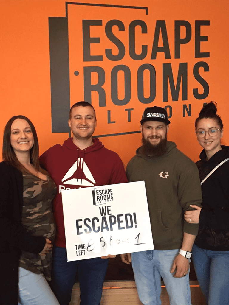 Escape room team celebrating victory at Quest for Directions, advanced escape sequences, fun group activity, team-building experience.