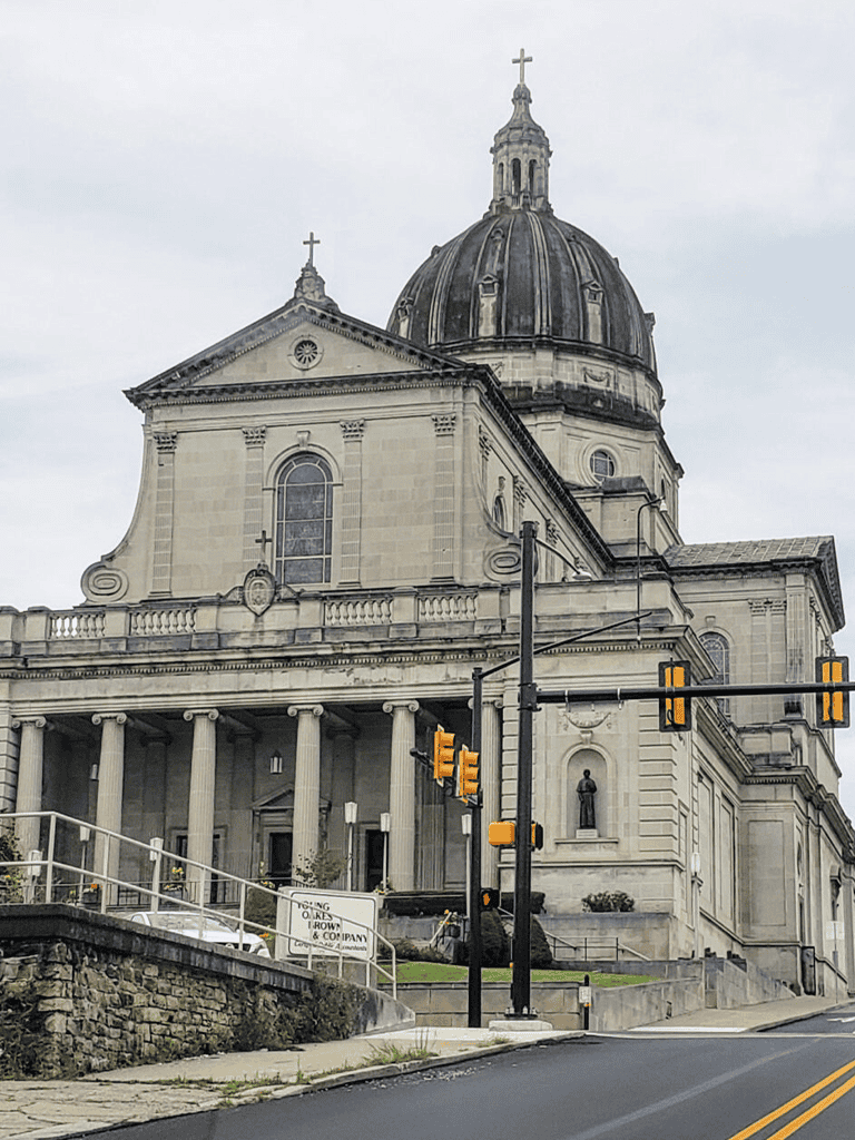 Majestic church with large dome and classical architecture, located in downtown city area.