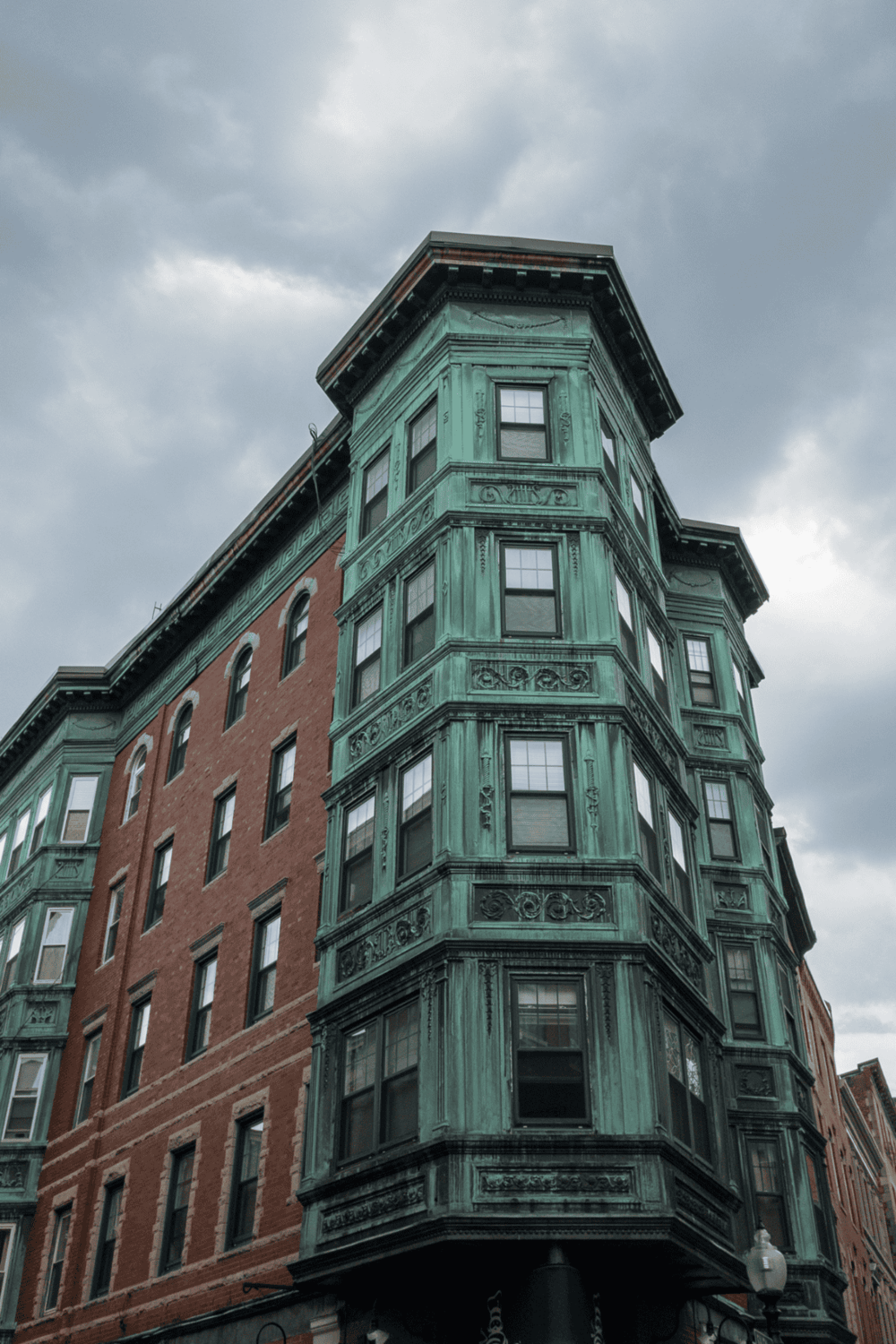 Historic building with ornate green copper exterior and classic architecture.