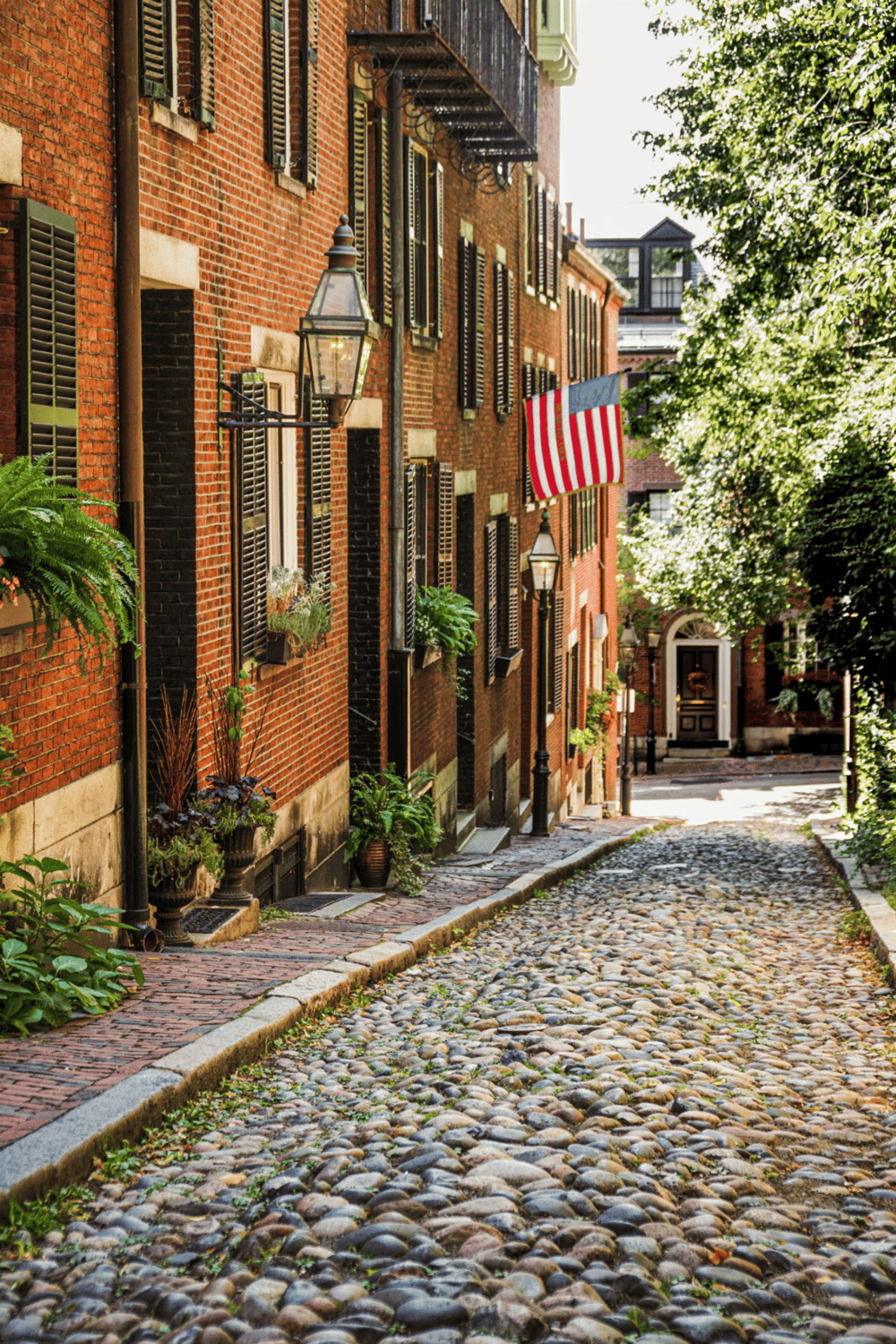 Weathered cobblestone street in historic brick neighborhood, perfect for exploring American charm.