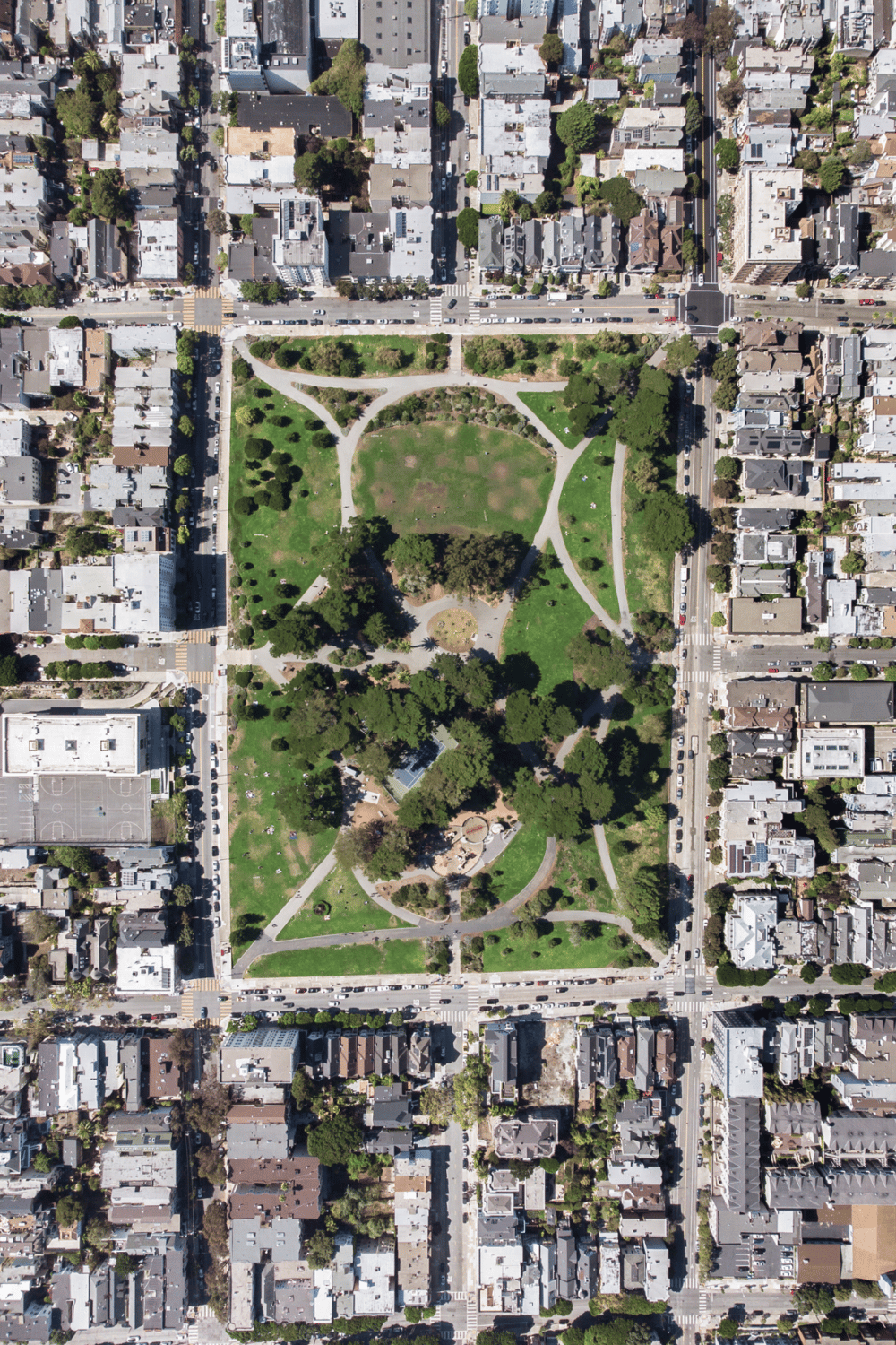 Aerial view of city park surrounded by urban buildings and streets in San Francisco.