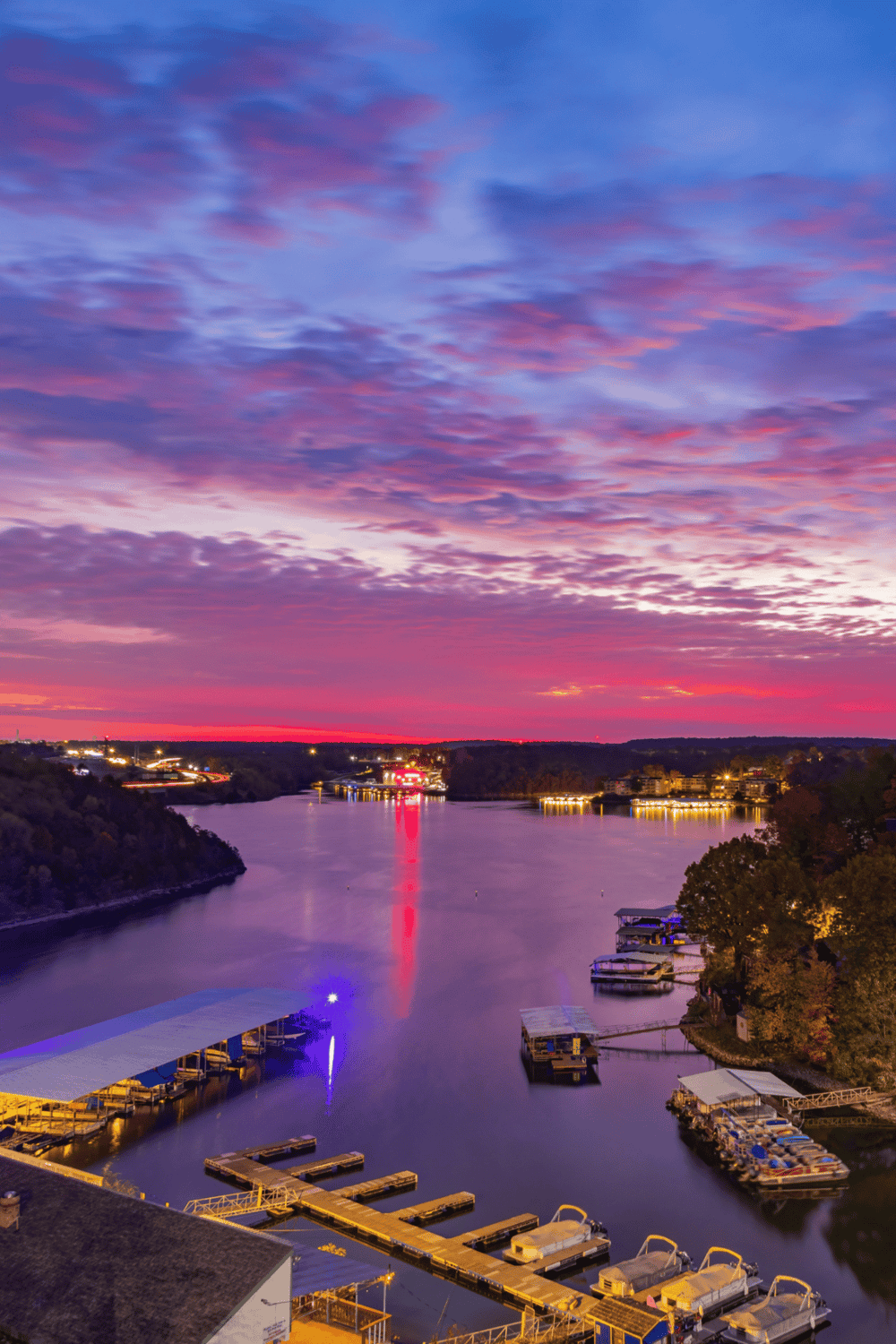 Stunning sunset over a calm river with docks and boats, perfect for traveler navigation and scenic views.
