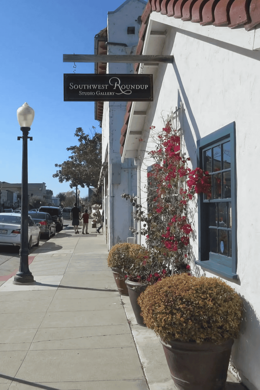 Southwest Roundup Studio Gallery outdoor signage under bright blue sky.