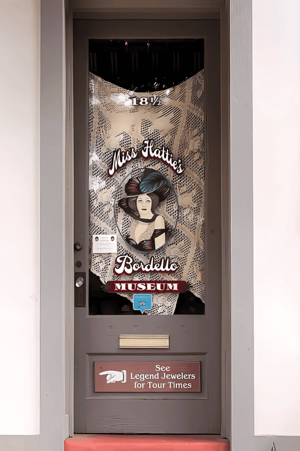 1. Miss Katie's Bordello Museum door with artistic design and informational signage.