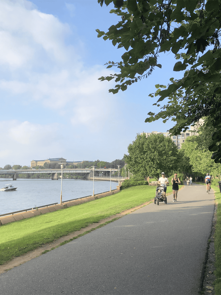 Relaxing riverside walking and jogging path with scenic views and lush greenery near Quest For Directions.